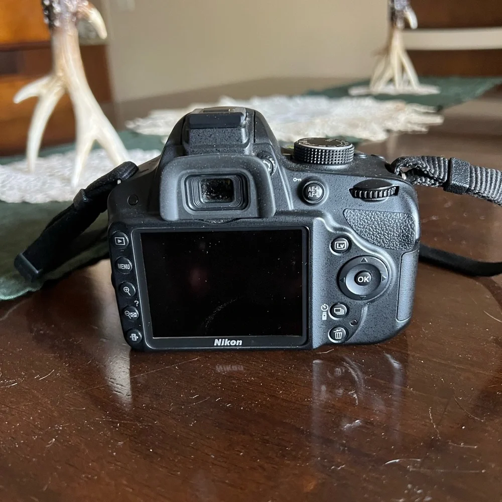 Nikon DSLR Camera in Black with Yellow-Accent Strap